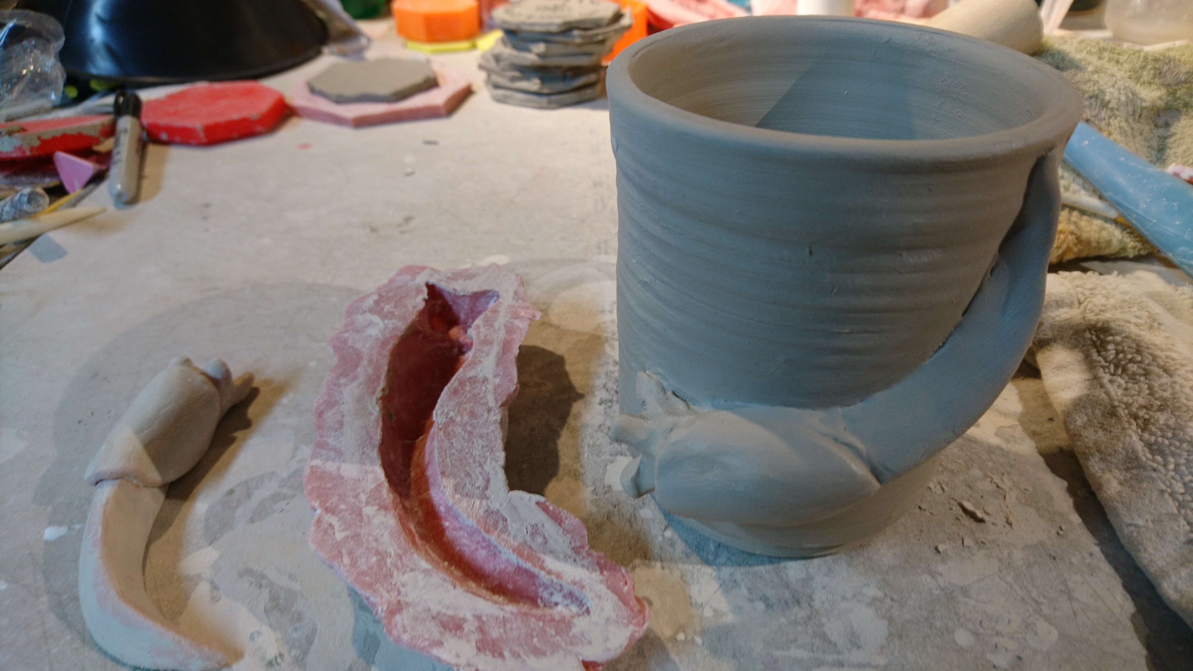slug sculpture, mold, and slug on mug