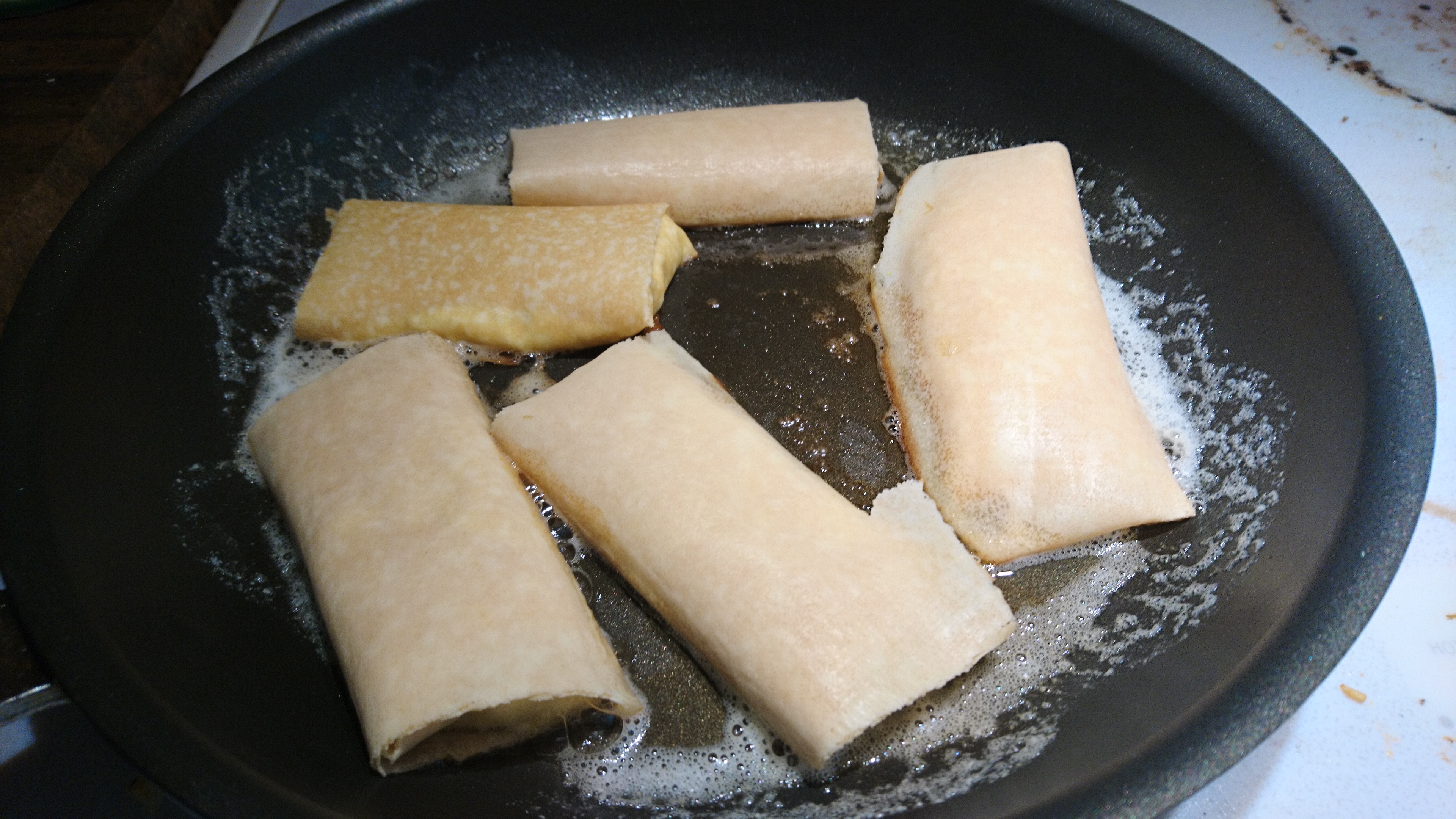 blintzes in a frying pan with butter