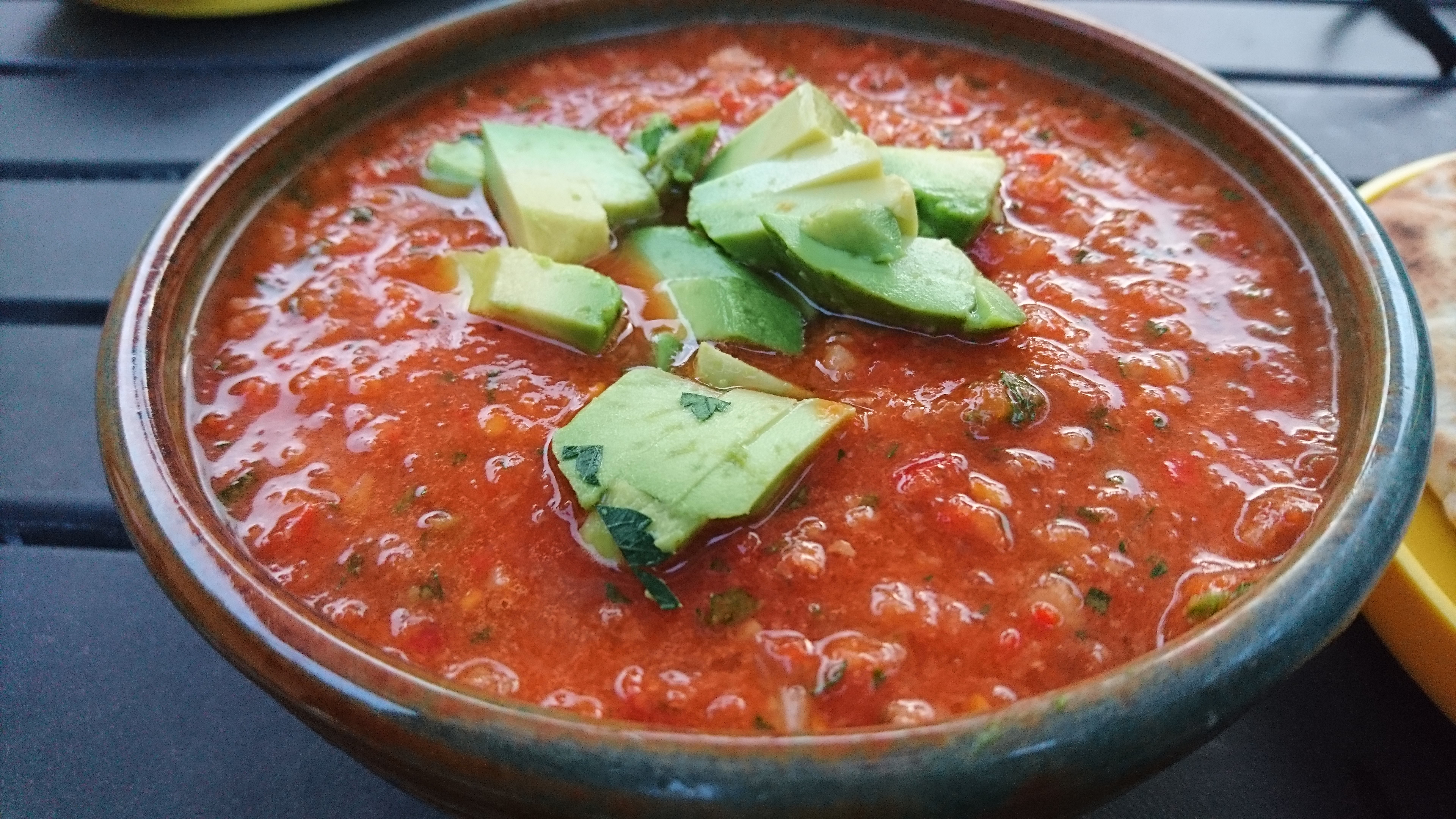 bowl of gazpacho topped with diced avocado