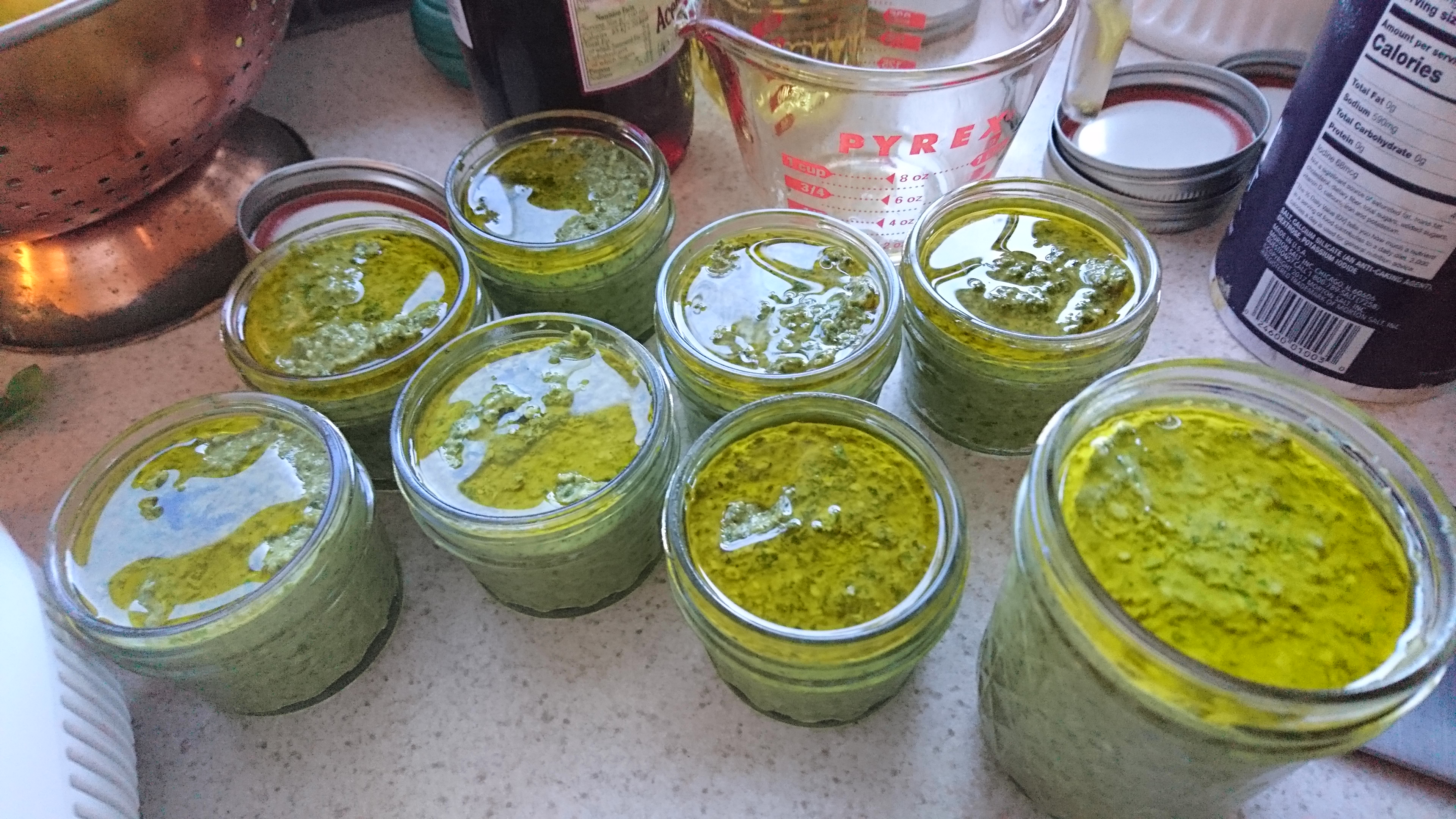 8 open jars of pesto