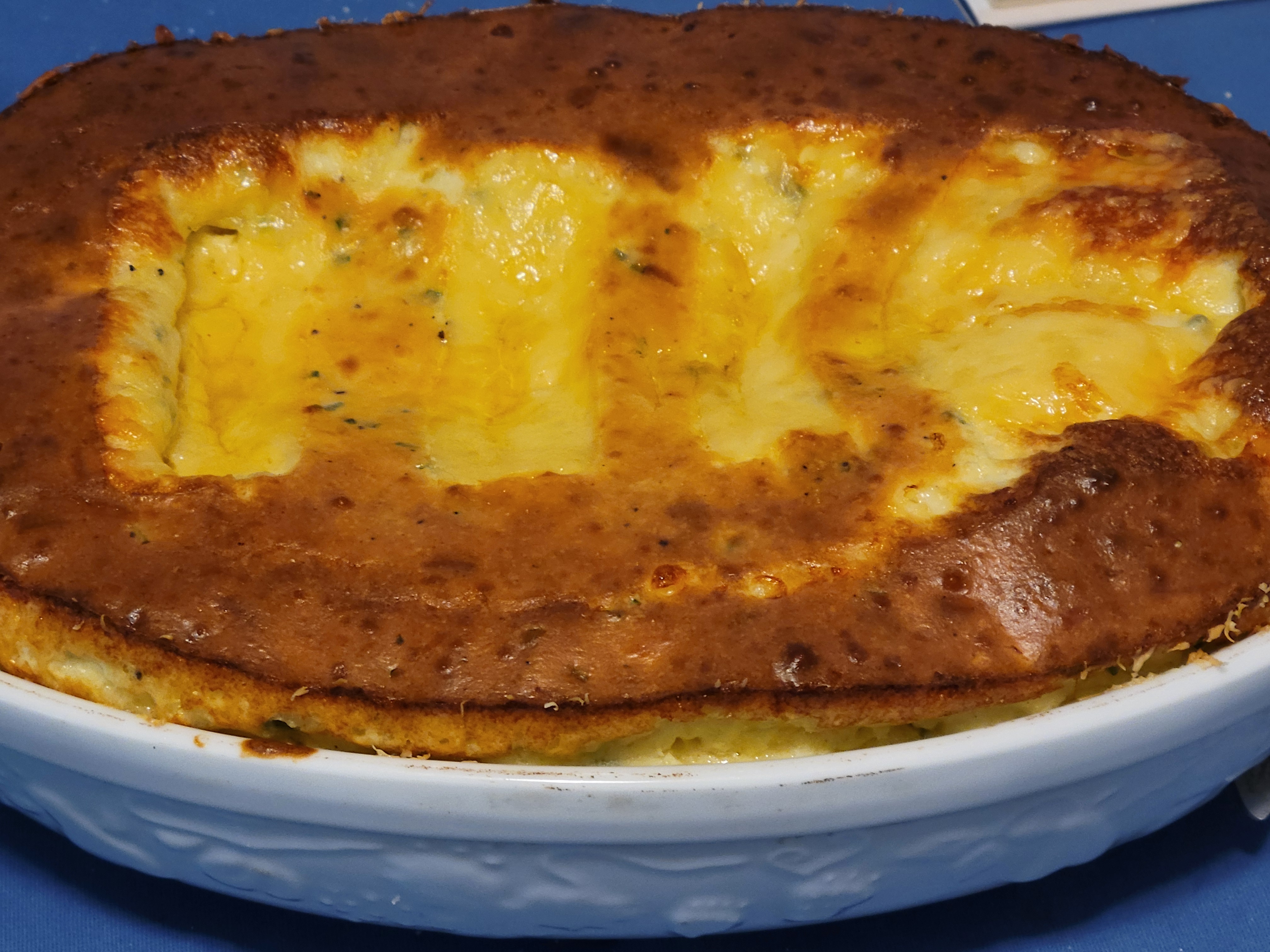 crusty souffle in a gratin dish, with browned top and four 