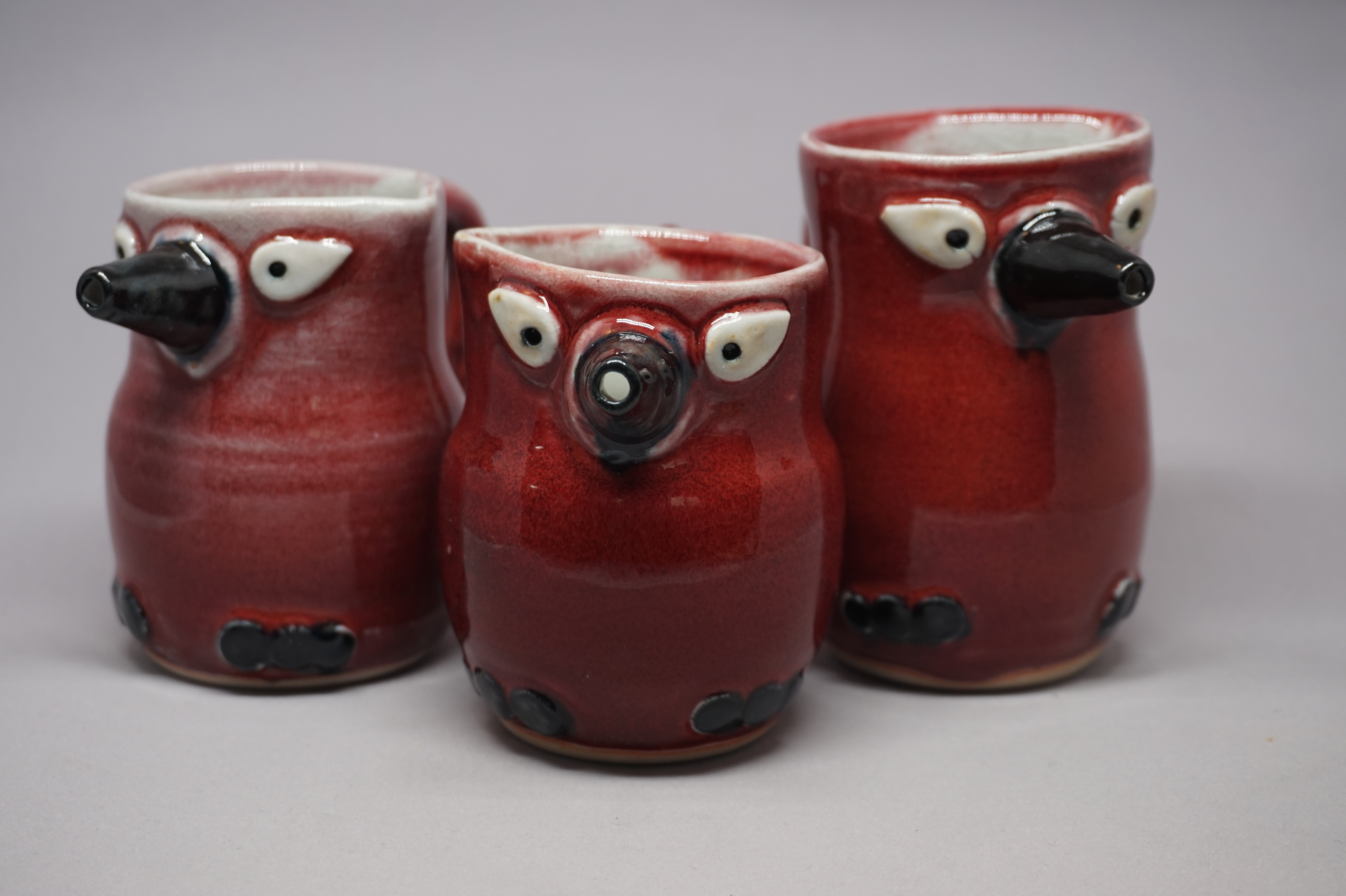 three red syrup birds