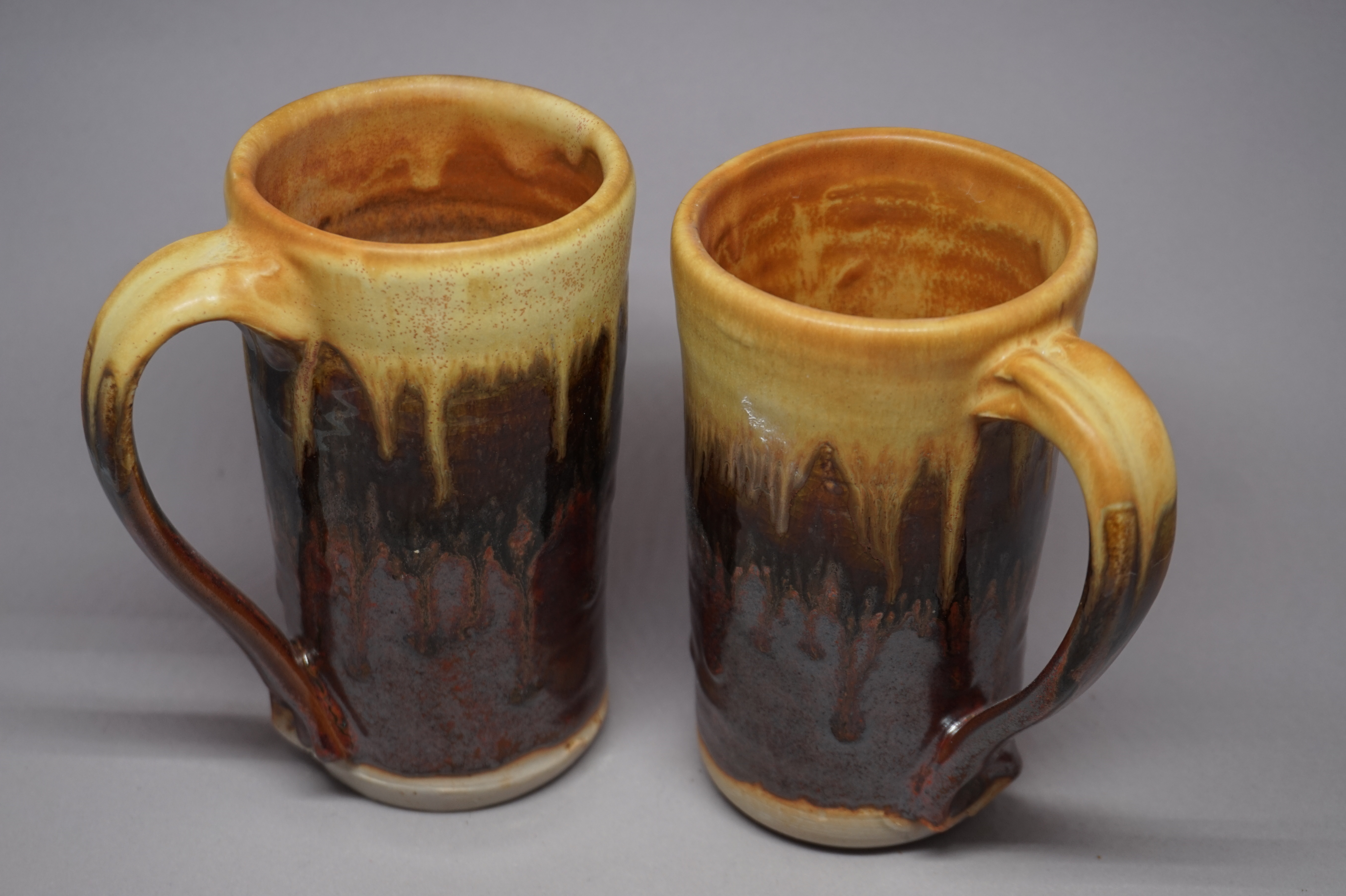 two streaky orange-and-brown mugs