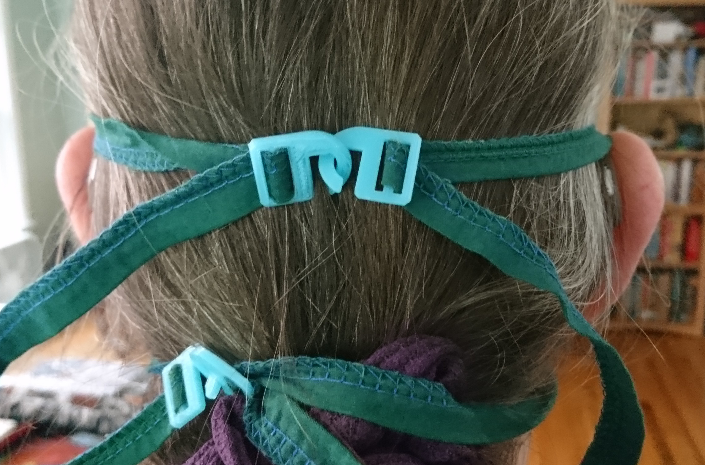 photo of hook clasp mask ties on long-haired person