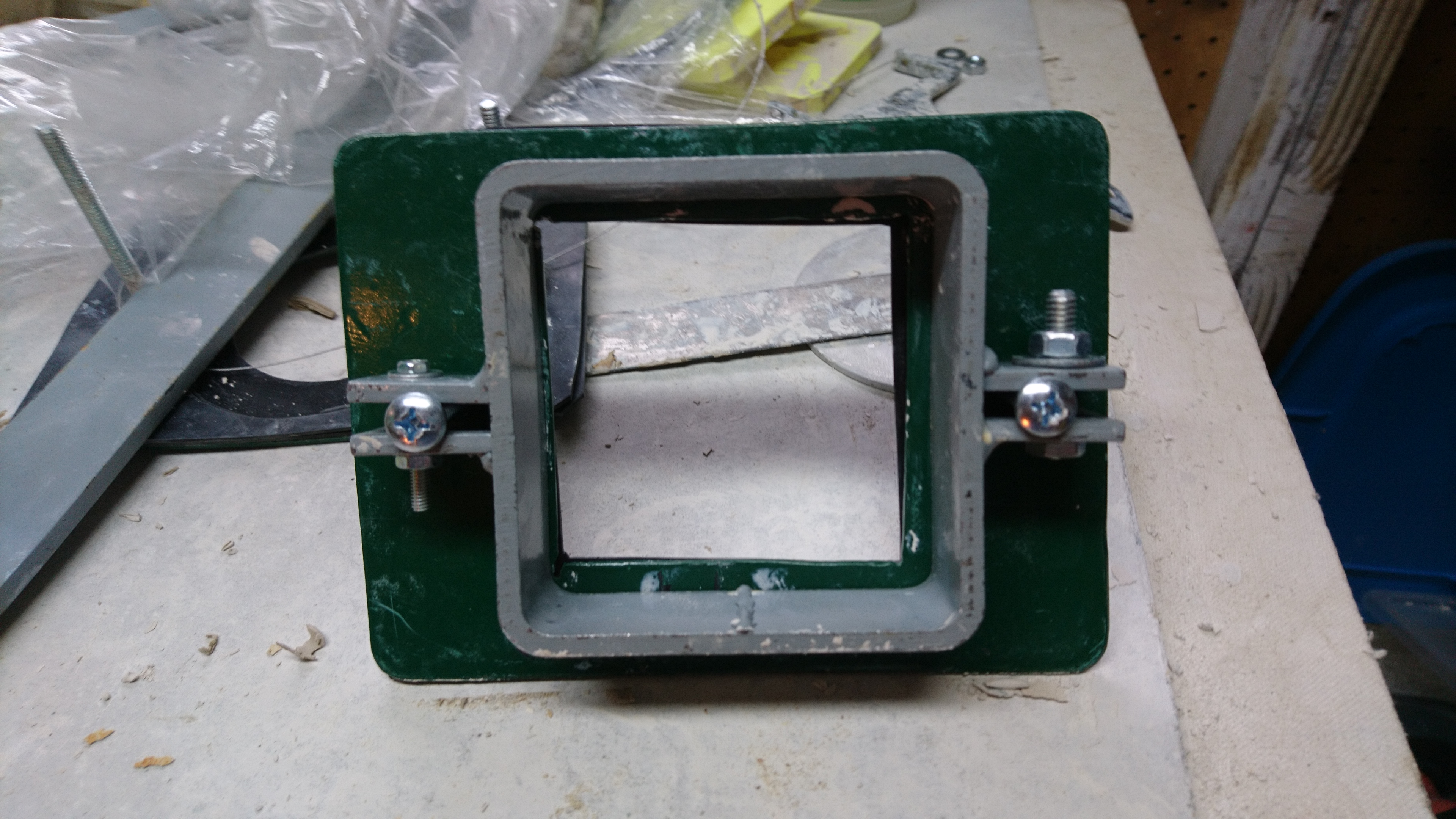 extruder bottom assembly with metal retaining plate