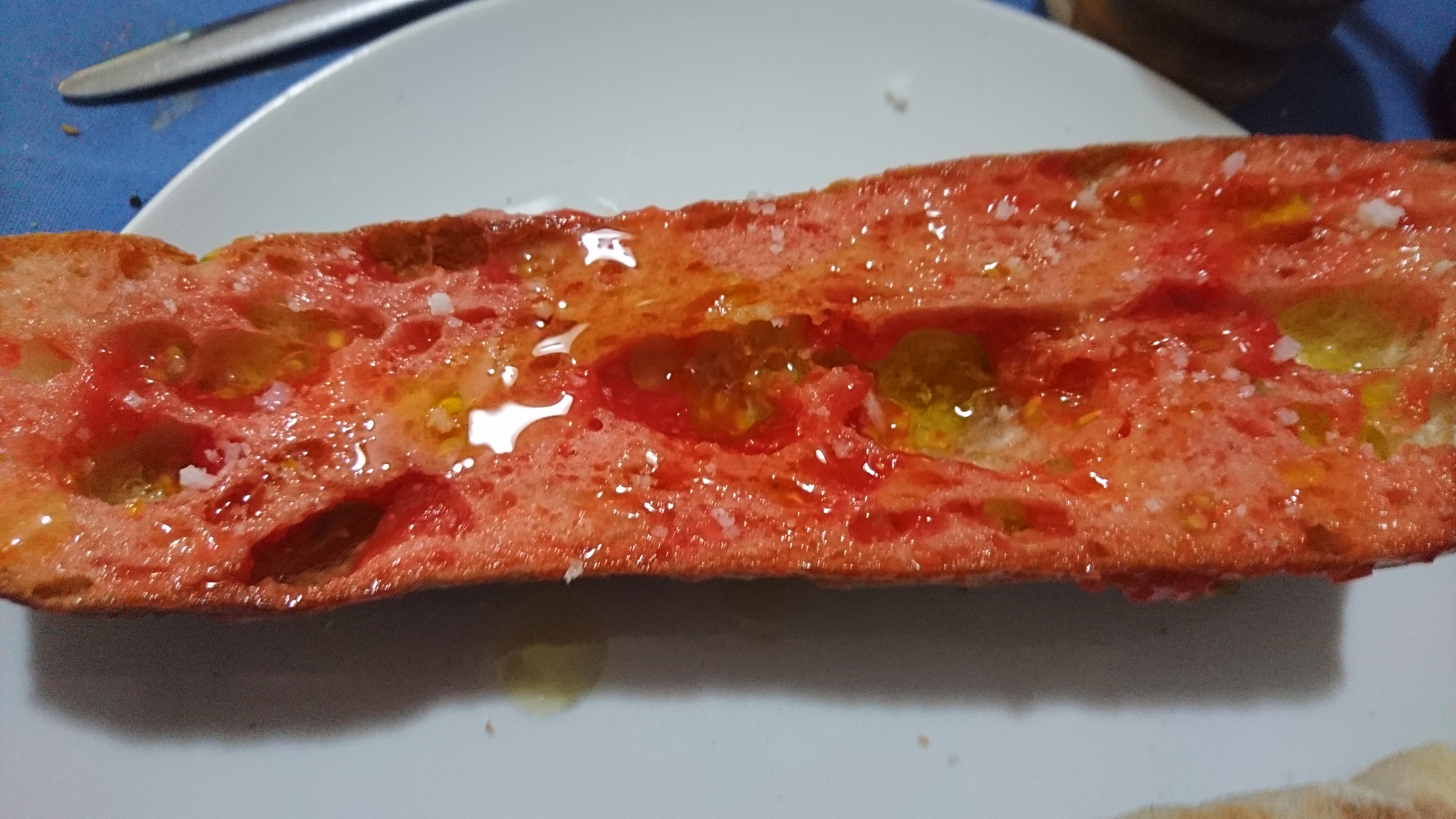 plate with long piece of pan con tomate