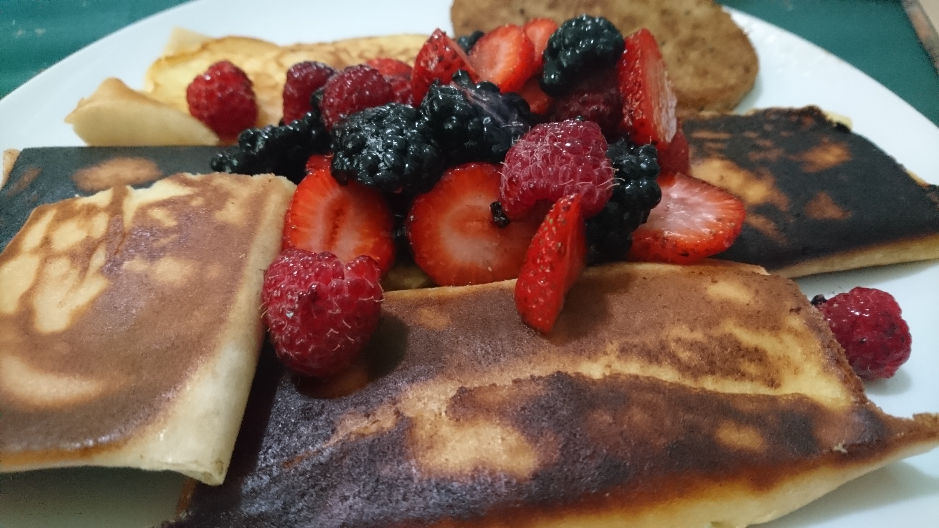blintzes with fresh strawberries on a plate