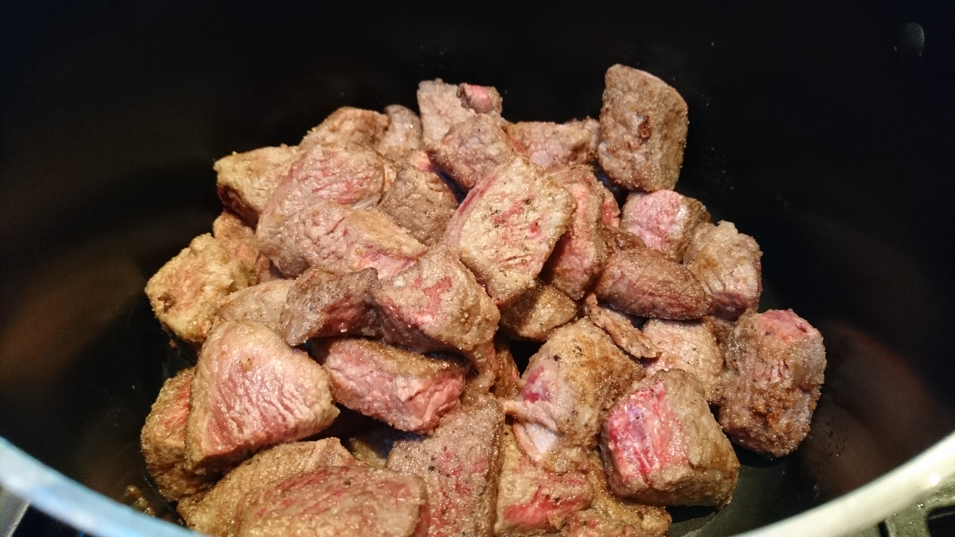 velveted beef frying in a pot