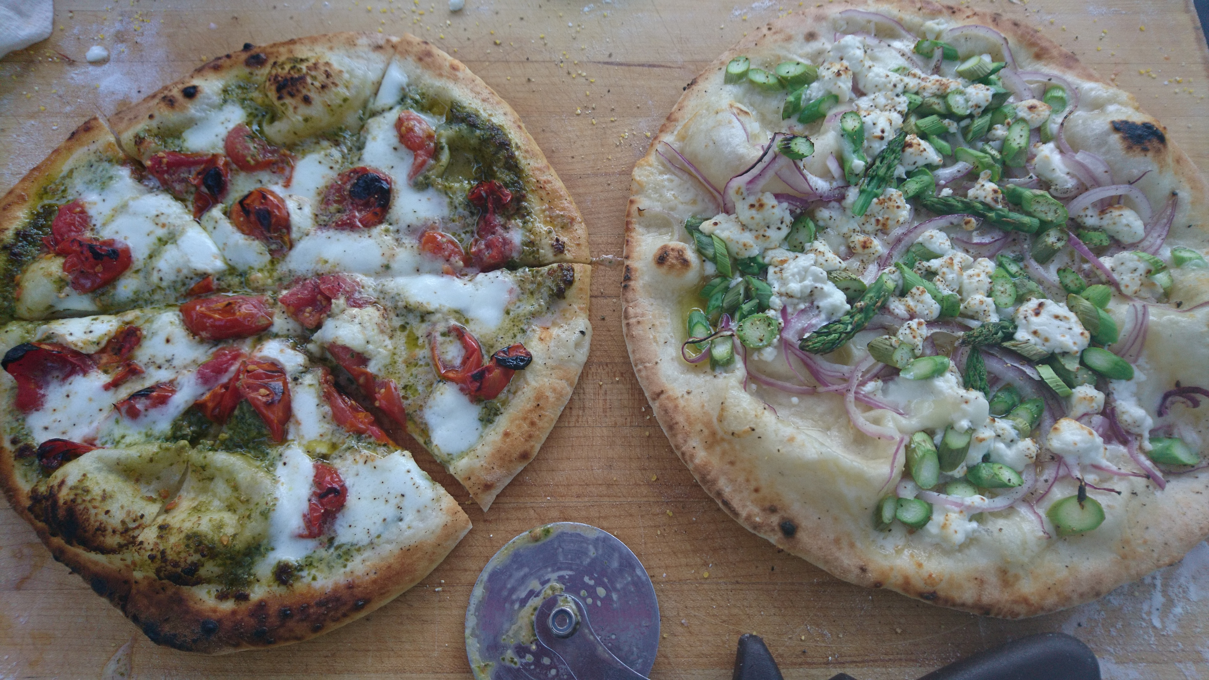 two pizzas, one asparagus/feta, one 