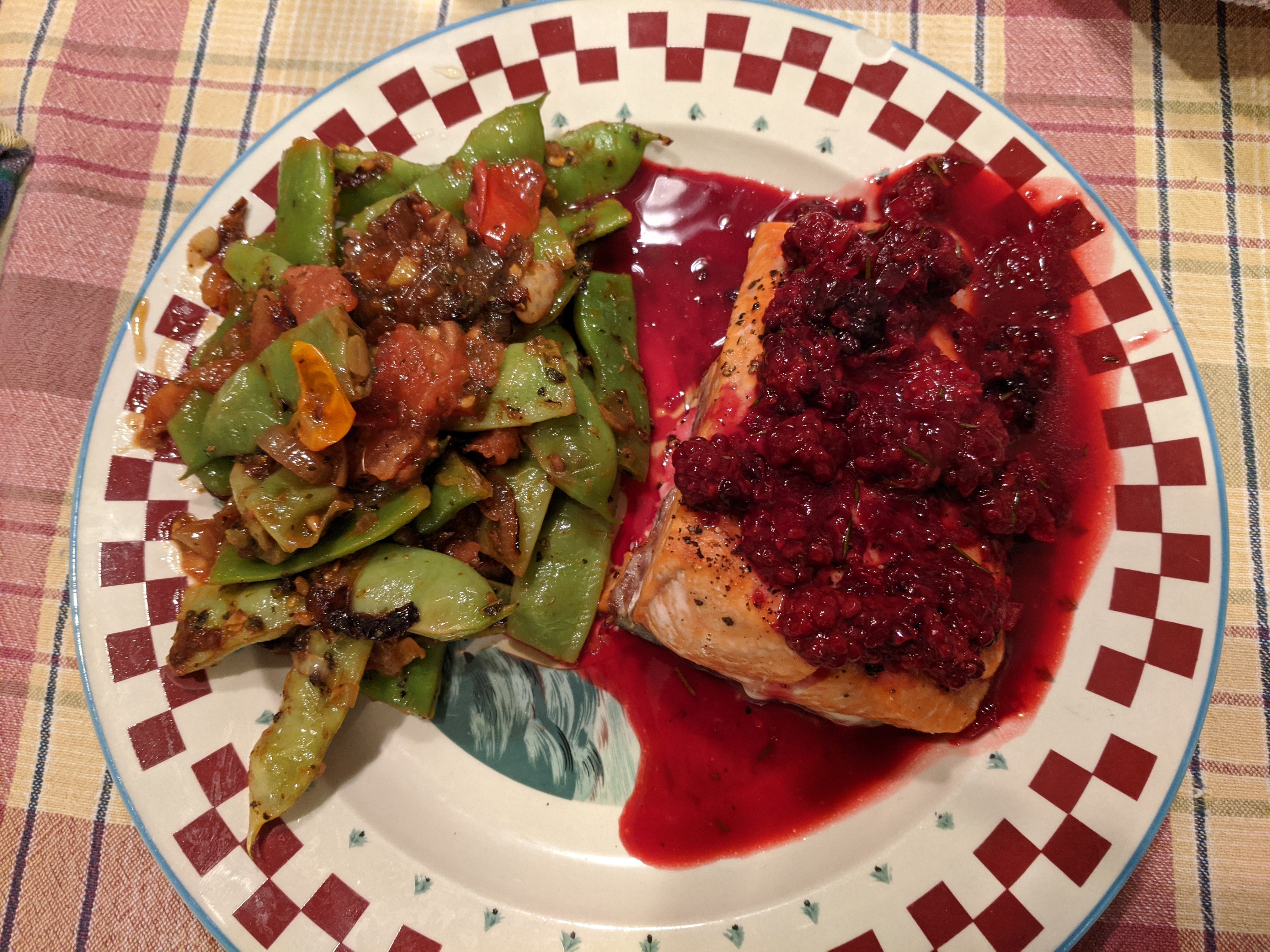salmon with blackberries, on a plate with green bean ragout
