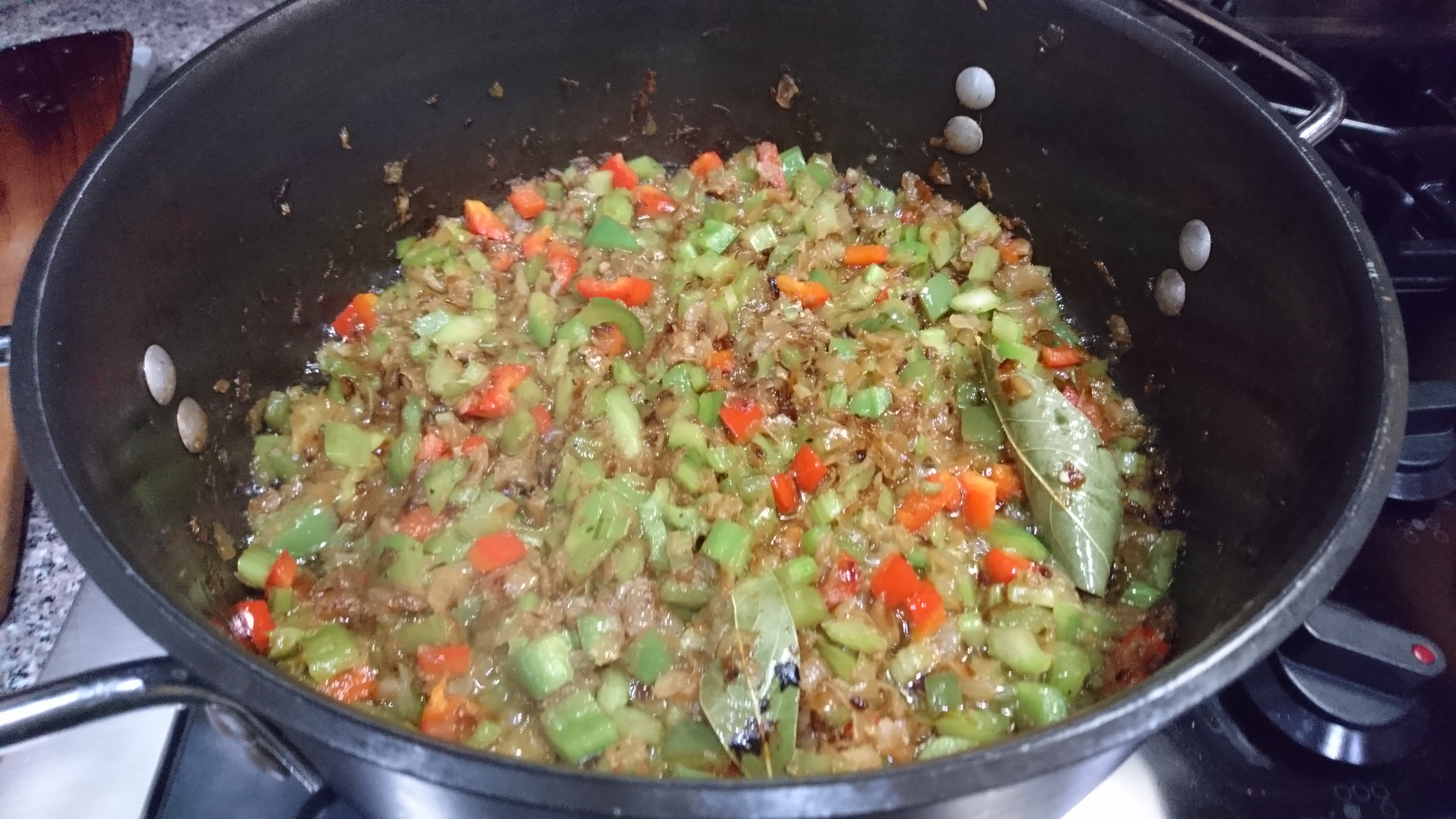 onions, peppers, and celery cooking in a large pot