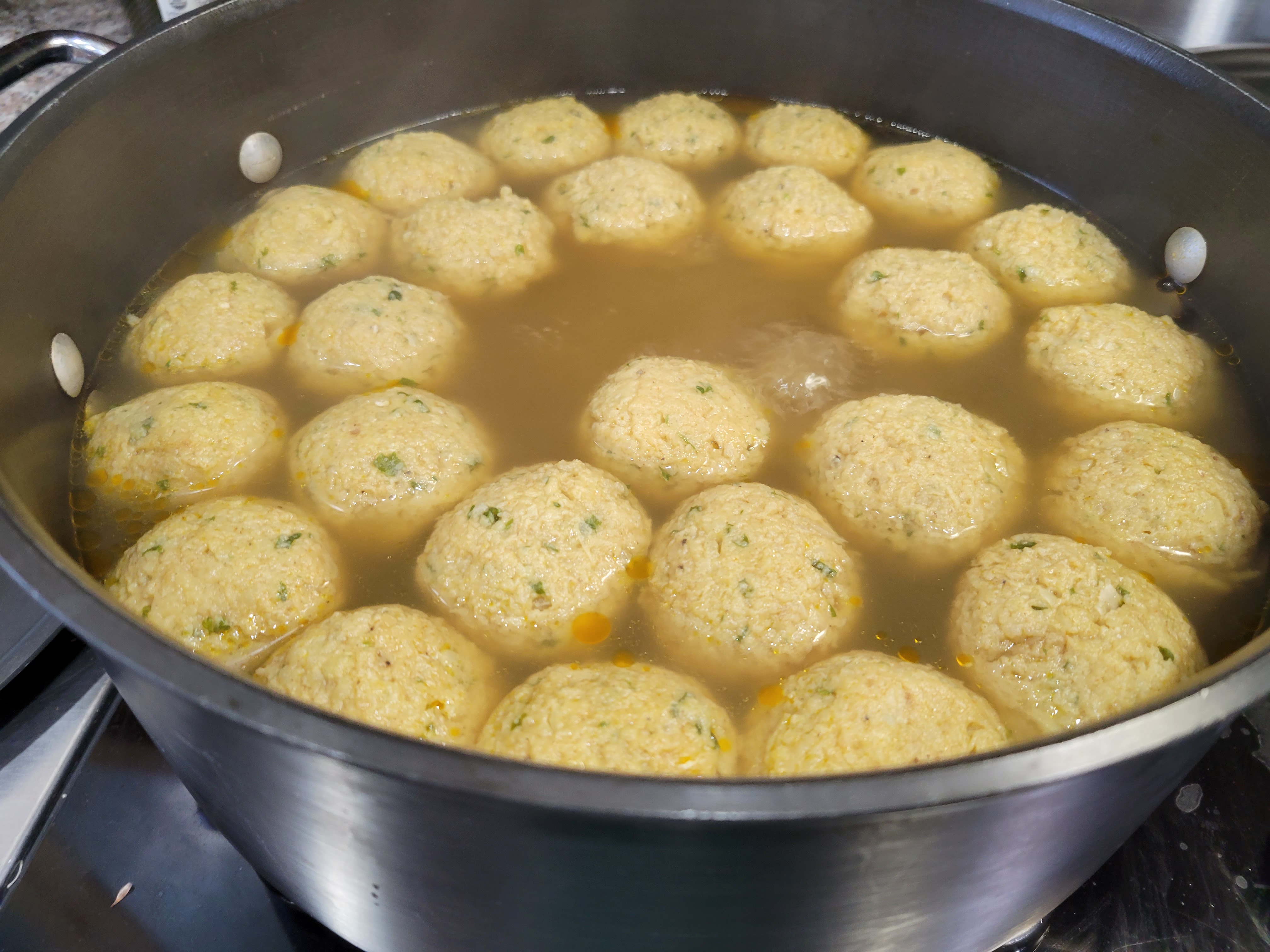 finished, plump matzoh balls in the pot