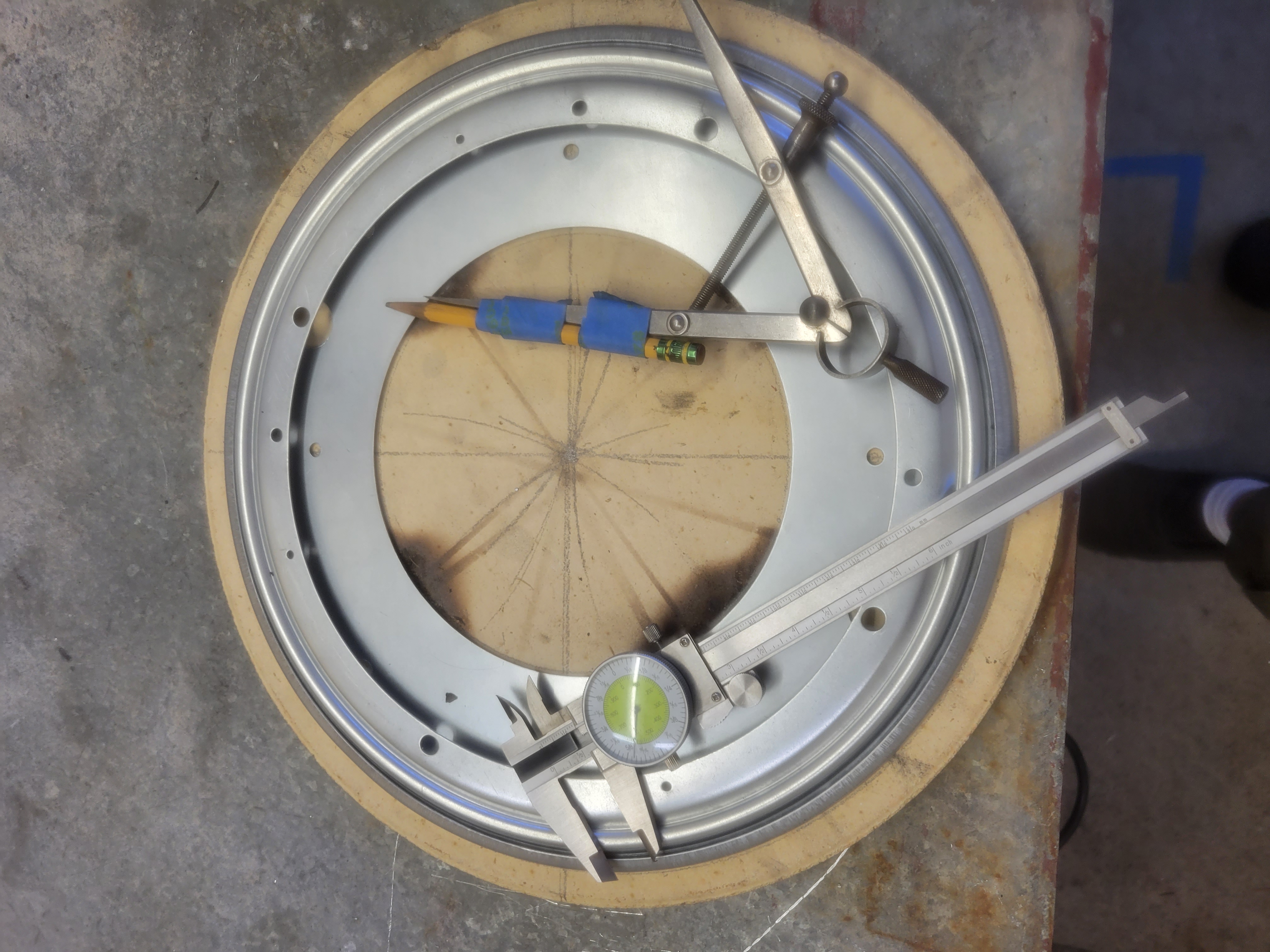 the lazy susan, centered on the stone, topped with a compass and measuring guage