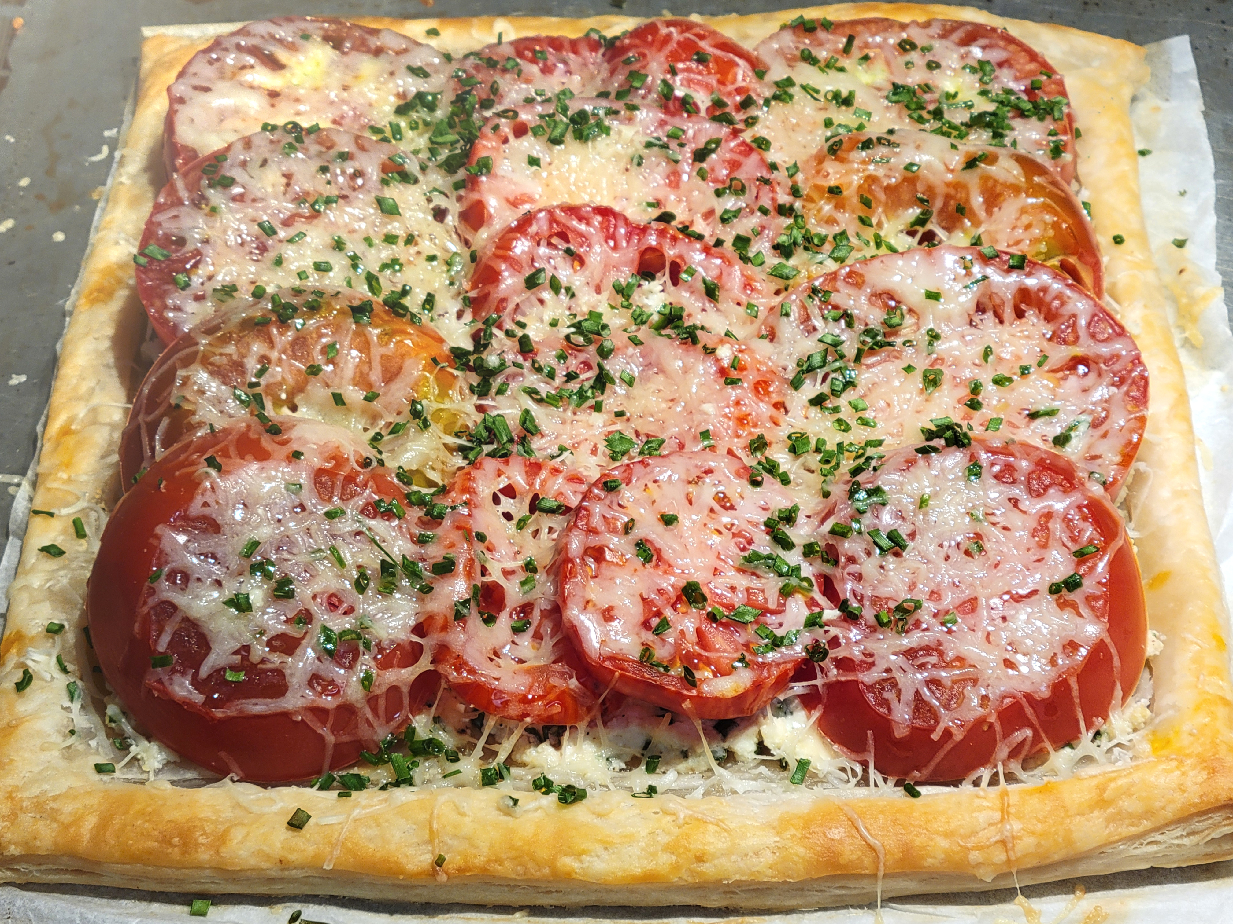 square tomato and puff pastry tart with overlapping tomato slices